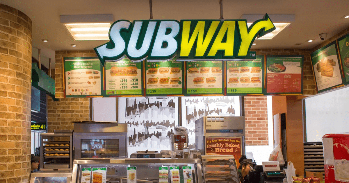Interior of a Subway franchise location showing menu boards and ordering counter - franchise advantages illustrated through standardized branding.