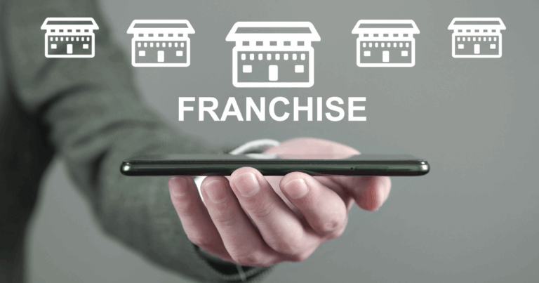 Business professional holding smartphone with franchise store icons, illustrating digital franchise marketing strategies for expansion.