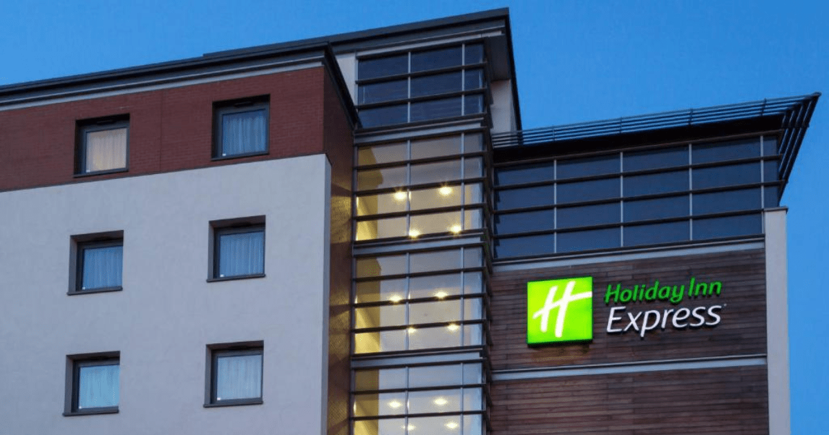 Modern Holiday Inn Express exterior showcasing franchise growth through architectural brand standards and visual identity elements.