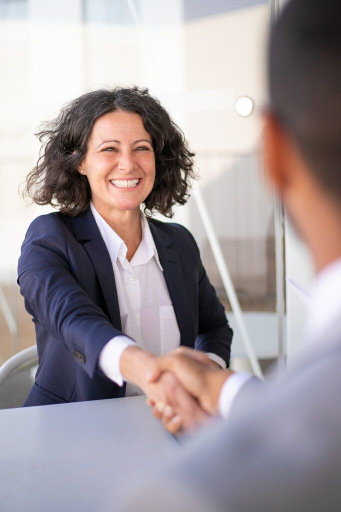 Two executives shaking hands after choosing franchise consultants for business expansion
