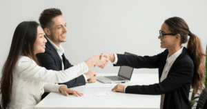 Business professionals shaking hands, representing successful franchise recruitment and investor partnerships.