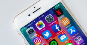 Smartphone displaying essential social media for franchises including Instagram, Facebook, Twitter and YouTube apps.