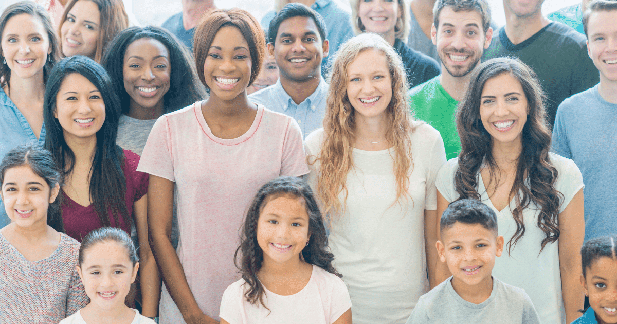 Diverse community members smiling together, showcasing successful franchise community engagement through inclusive local connections