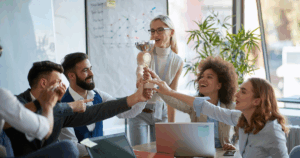 Business team celebrating a performance award, demonstrating how recognition-based franchise incentives boost team morale and motivation.
