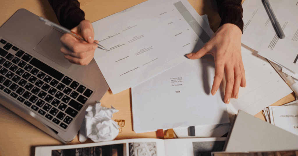 Business owner reviewing FDD drafts and legal documents during franchise development process.