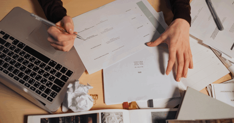 Business owner reviewing FDD drafts and legal documents during franchise development process.