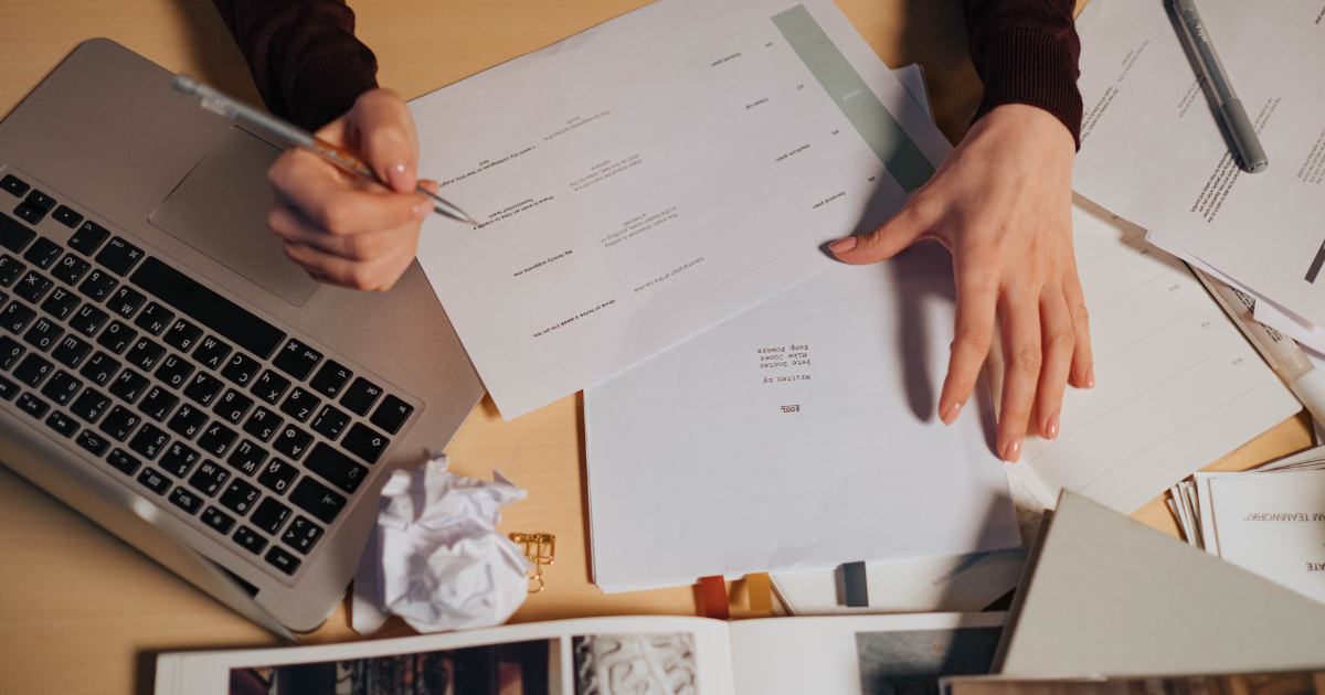 Business owner reviewing FDD drafts and legal documents during franchise development process.