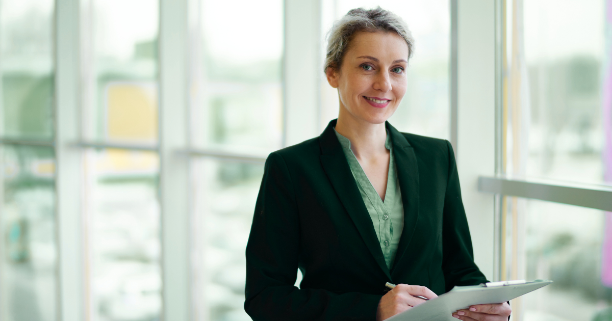Professional woman holding a clipboard in a bright office, representing expert guidance and strong franchise consultant ROI.