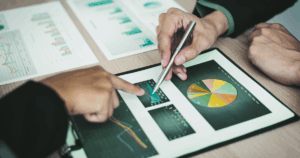 Business owner presenting franchise operations manuals to team members for consistent growth.