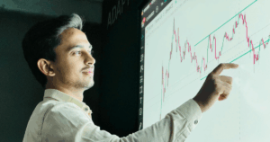 Consultant reviewing franchise data forecasting dashboard for predictive analytics franchises