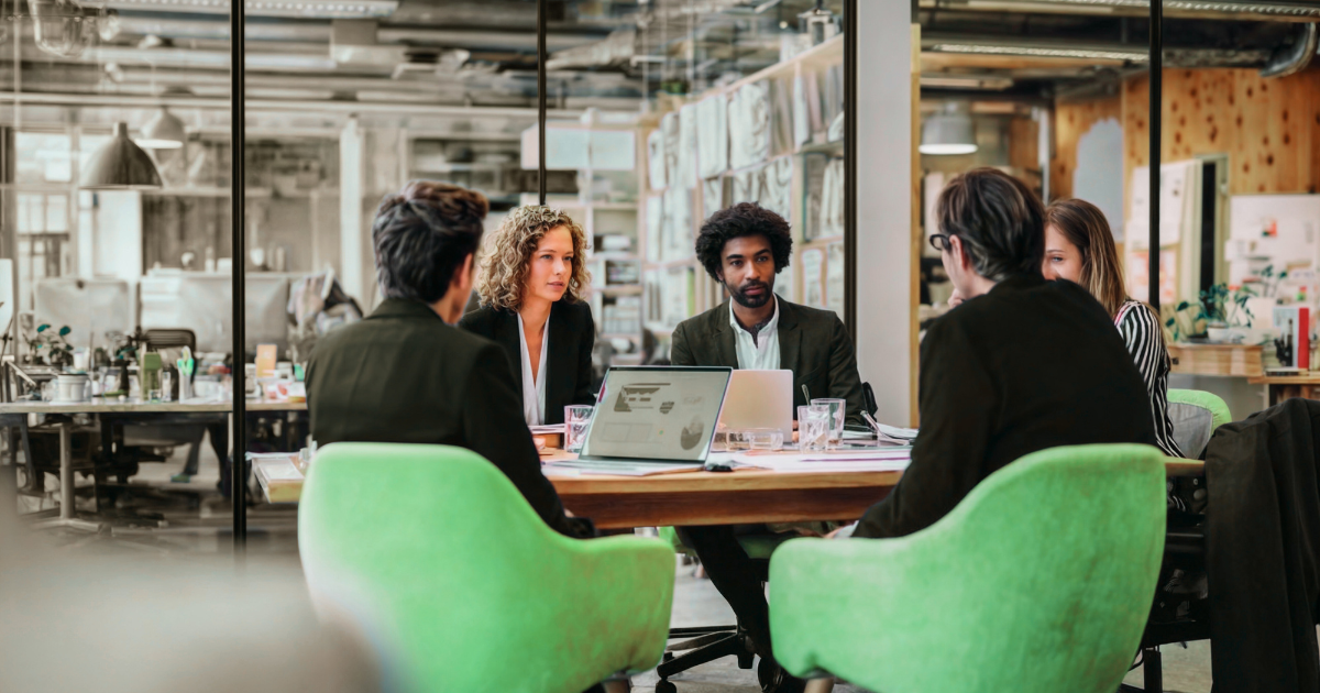 A franchise leadership team reviewing performance reports during an efficiency audit to improve system operations.