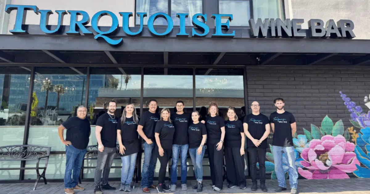 1. Turquoise Wine Bar team outside flagship location, featured in a franchise case study on scaling a community-driven brand